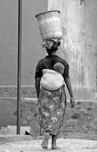 Women carrying child and washing, Kenya Women carrying child and washing, Kenya